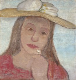 Ragazza con il cappello di paglia e un fiore in mano