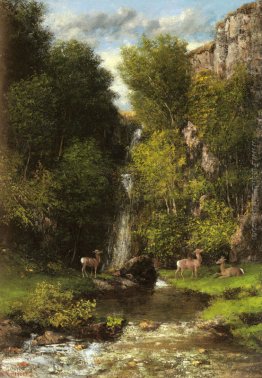 Una famiglia di Cervo in un paesaggio con una cascata